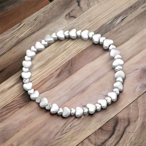 silver double heart necklace on wood