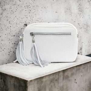 white leather crossbody on shelf