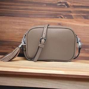 coffee bag with silver hardware and adjustable strap