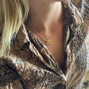 gold penny necklace on model
