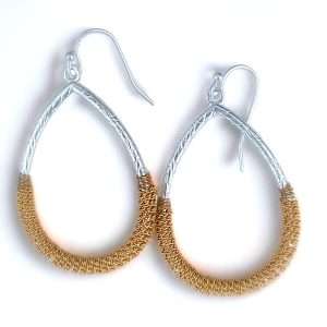 ladies peirced teardrop shaped earrings with gold chain detail