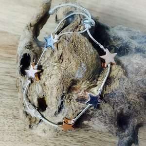 two tone star friendshipbracelet on driftwood