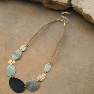 gold resin necklace on stone background