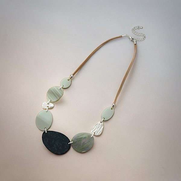 resin necklace on plain background
