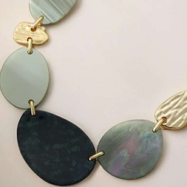 close up of resin and gold detail on necklace