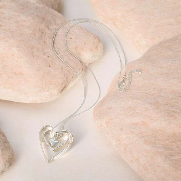 silver hearts necklace with a stone background