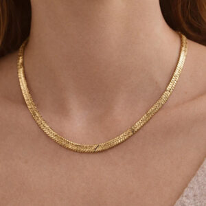woman wearing gold animal print necklace