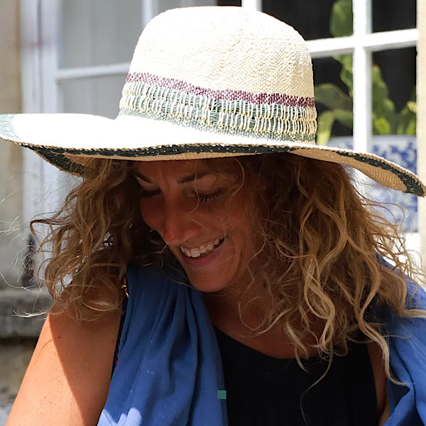 woman wearing wide brim sun hat beach