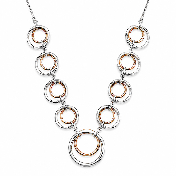 ## Rose Gold & Silver Double Circle Necklace Bring contemporary style to your jewellery collection with this beautiful rose gold and silver double circle necklace. The mixed metal design combines soft rose gold with polished silver, creating an elegant look that is both modern and timeless. As a result, it complements both everyday outfits and special occasion wear. This necklace features two interlocking circles suspended from a fine chain. The combination of rose gold and silver tones creates a stylish contrast that pairs beautifully with a wide range of jewellery. At the same time, the polished finish catches the light and adds a subtle sparkle. The necklace measures 45cm and includes a 6cm extender chain. Therefore, you can easily adjust the length to suit different necklines and styles. The lightweight design also makes it comfortable enough to wear throughout the day. Wear this double circle necklace on its own for a simple and elegant look. Alternatively, layer it with longer chains for a contemporary jewellery style. Because of this, it is a versatile piece that works beautifully from day to evening. The mixed metal finish makes this necklace easy to wear with both rose gold and silver jewellery. In addition, the classic interlocking circle design gives it lasting appeal that never goes out of fashion. For a coordinated finish, pair it with the matching rose gold and silver bracelet. Together, they create a beautiful jewellery set that is perfect for every occasion. Finally, this rose gold and silver necklace makes a thoughtful gift. It is ideal for birthdays, anniversaries, Mother's Day, Christmas, or simply treating yourself. ### Key Features * Rose gold and silver plated finish * Double interlocking circle design * Fine chain necklace * Lightweight and comfortable * Adjustable length * 45cm chain * 6cm extender chain * Matching bracelet available ### Styling Ideas * Wear alone for a simple look * Layer with longer necklaces * Pair with the matching rose gold and silver bracelet * Mix with rose gold and silver jewellery * Style with casual or occasion wear ### Perfect For * Everyday jewellery * Mixed metal styling * Layering necklaces * Gift ideas * Birthday gifts * Anniversary gifts * Mother's Day gifts * Special occasions ### Product Specifications * Length: 45cm * Extender Chain: 6cm * Material: Rose Gold and Silver Plated Metal * Style: Short Necklace * Design: Double Interlocking Circles ### SEO Title Rose Gold & Silver Double Circle Necklace | Mixed Metal Necklace ### Meta Description Rose gold and silver double circle necklace with interlocking circles, fine chain and 6cm extender. Lightweight mixed metal necklace with matching bracelet available. ### Focus Keyphrase rose gold and silver double circle necklace ### Related Keyphrases * rose gold and silver necklace * mixed metal necklace * double circle necklace * interlocking circle necklace * layered necklace * rose gold jewellery ### Strategic Synonyms * rose gold mixed metal necklace * interlocking circle pendant necklace * rose gold and silver pendant necklace ### Image Alt Tags * rose gold and silver double circle necklace * mixed metal circle necklace * rose gold silver pendant necklace * interlocking circle necklace * rose gold and silver necklace for women * mixed metal jewellery necklace ### Natural SEO Synonym Sentences * This rose gold mixed metal necklace adds a contemporary touch to any jewellery collection. * The elegant interlocking circle pendant necklace pairs beautifully with both rose gold and silver accessories. * This rose gold and silver pendant necklace is perfect for everyday styling and special occasions.