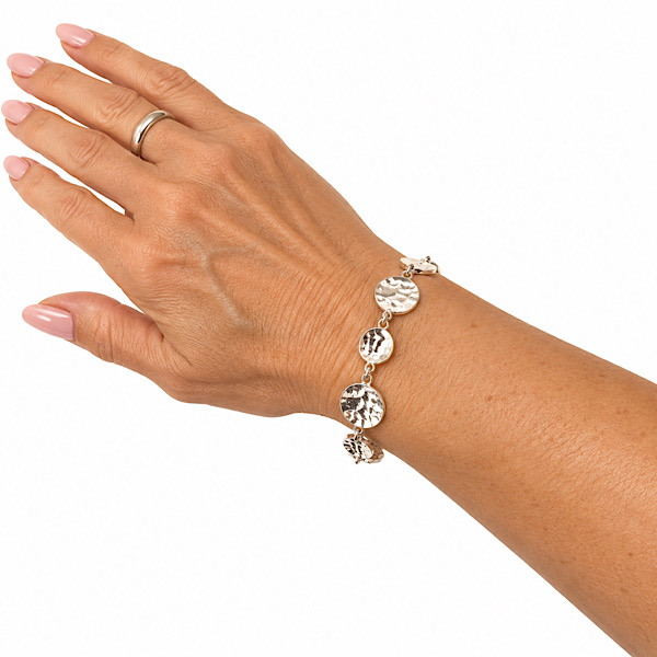 Texture silver disc on wrist